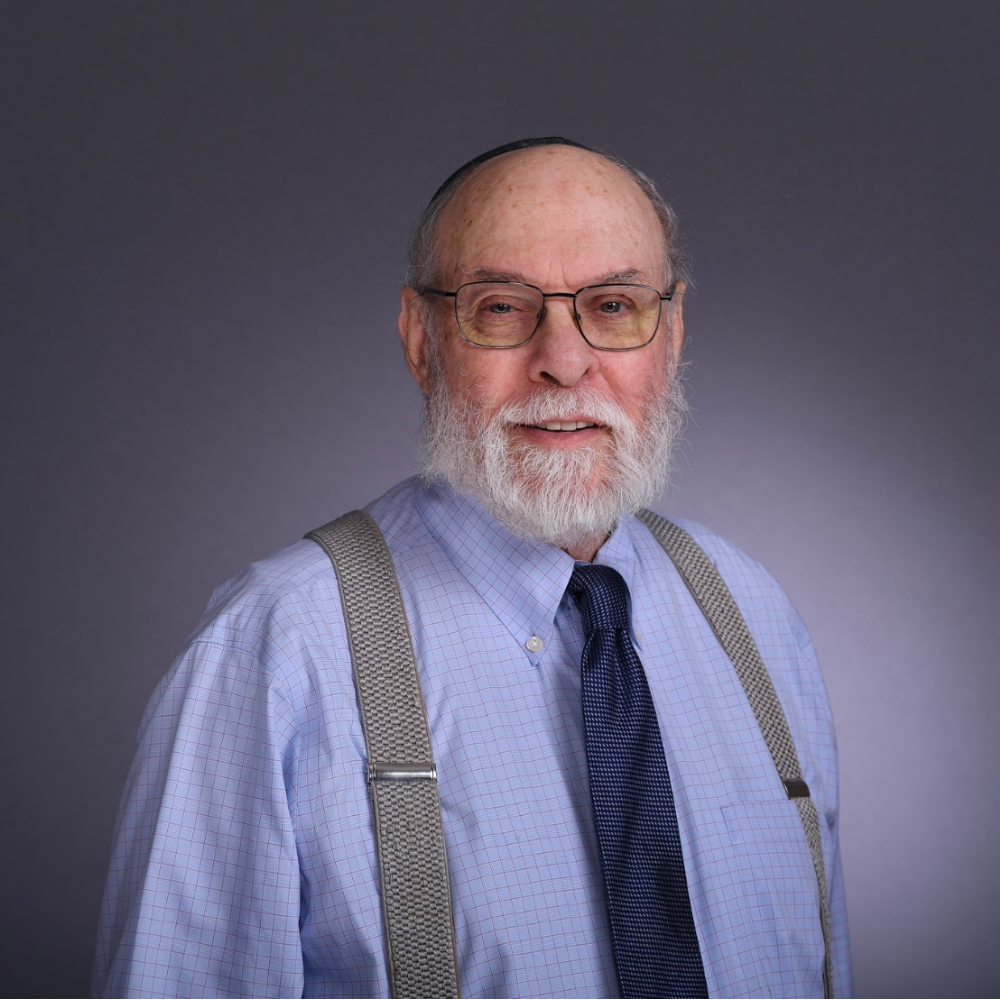 Headshot of Kenneth Astrin smiling.