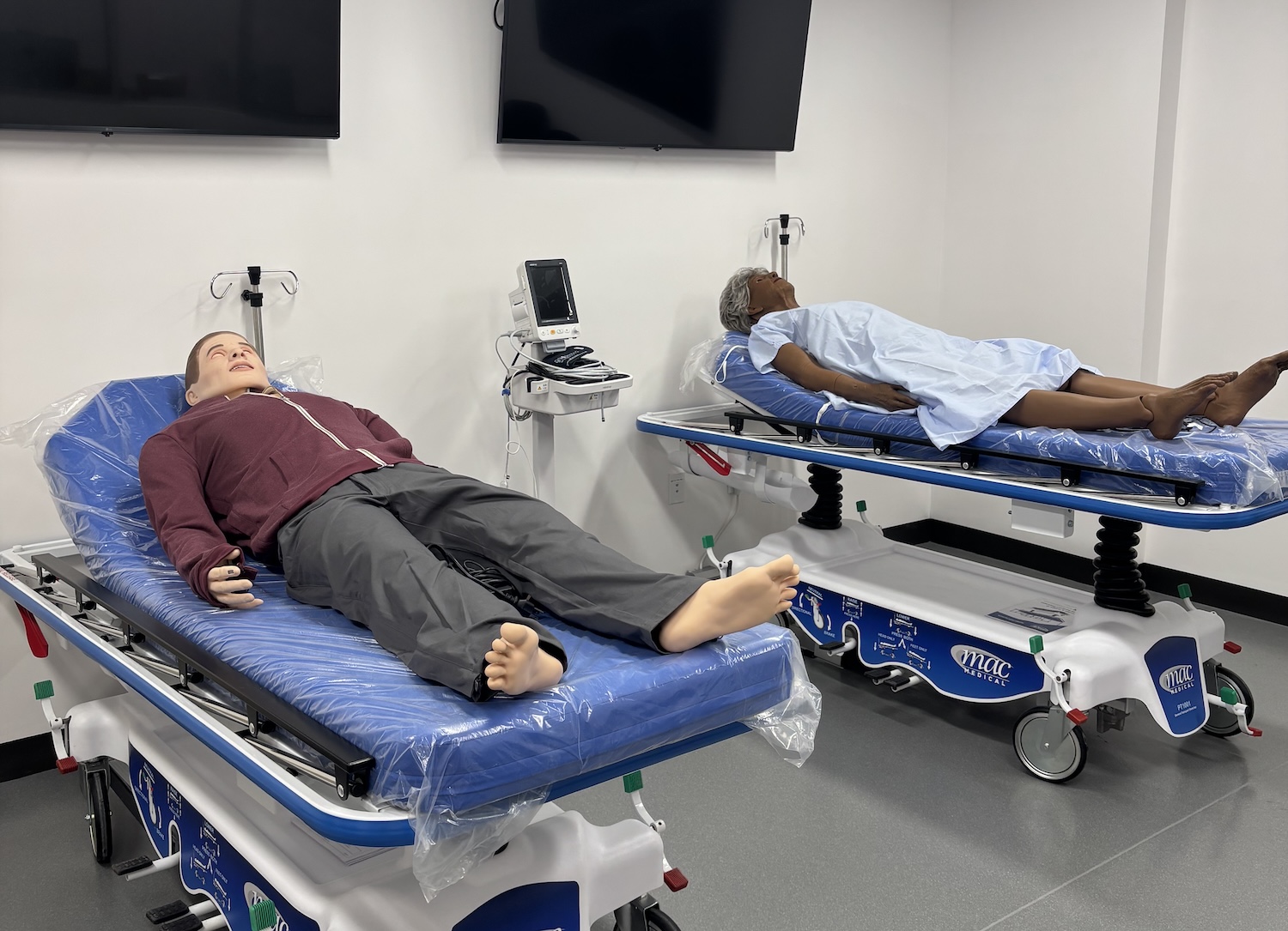 Two patient simulator lying on beds. 
