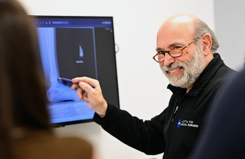Dr Rock Positano pointing to x-ray of foot